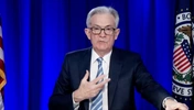 US Fed cuts bond-buying, plans for rate rises